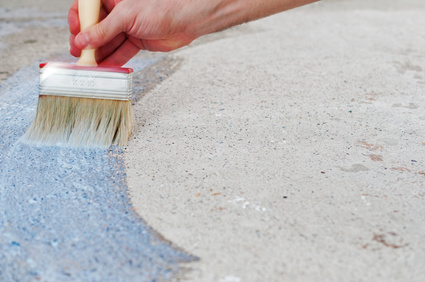 Coating the concrete floor with a brush